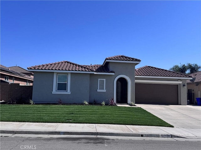 12073 Geode St, Jurupa Valley, CA 91752 - mediterranean / spanish-style house with an attached garage, concrete driveway, stucco siding, and a tile roof
