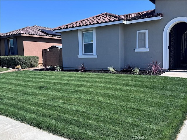 12073 Geode St, Jurupa Valley, CA 91752 - view of property exterior featuring a tiled roof, a yard, and stucco siding