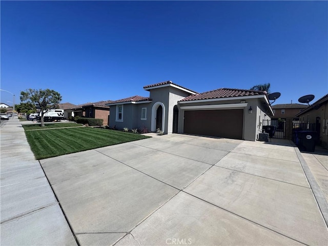 12073 Geode St, Jurupa Valley, CA 91752 - mediterranean / spanish-style home featuring an attached garage, stucco siding, driveway, and a tile roof