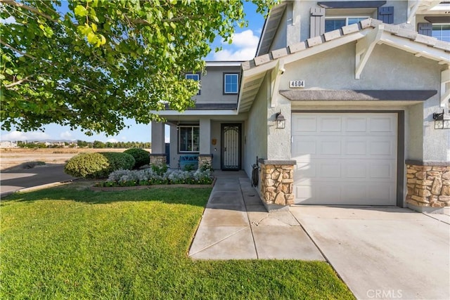 4604 Trojan Ct, Lancaster, CA 93536 - view of front of house featuring stone siding, stucco siding, a garage, a front lawn, and driveway