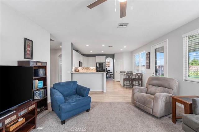 4604 Trojan Ct, Lancaster, CA 93536 - living area with ceiling fan, arched walkways, light wood-style flooring, and recessed lighting