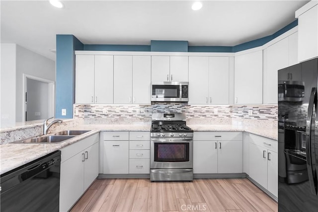 4604 Trojan Ct, Lancaster, CA 93536 - kitchen featuring black appliances, white cabinets, backsplash, recessed lighting, and light wood-style floors
