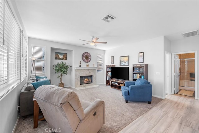 4604 Trojan Ct, Lancaster, CA 93536 - living area featuring a ceiling fan, a fireplace, and light wood-style flooring