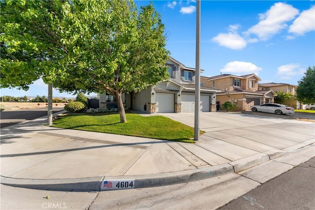 4604 Trojan Ct, Lancaster, CA 93536 - obstructed view of property featuring a garage, stucco siding, driveway, and a front lawn