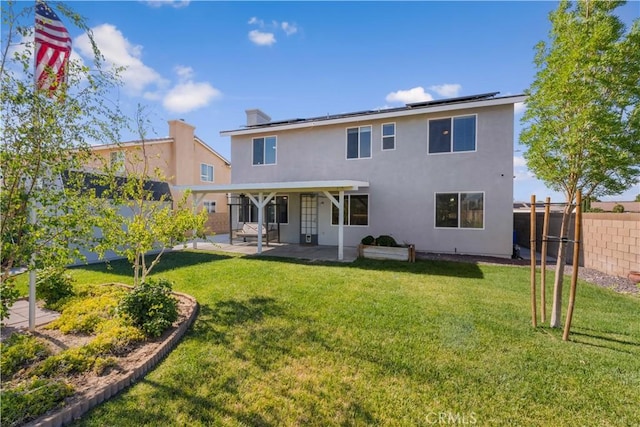 4604 Trojan Ct, Lancaster, CA 93536 - back of property with roof mounted solar panels, a patio, a fenced backyard, and stucco siding