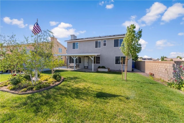 4604 Trojan Ct, Lancaster, CA 93536 - rear view of property featuring a patio, stucco siding, and a fenced backyard