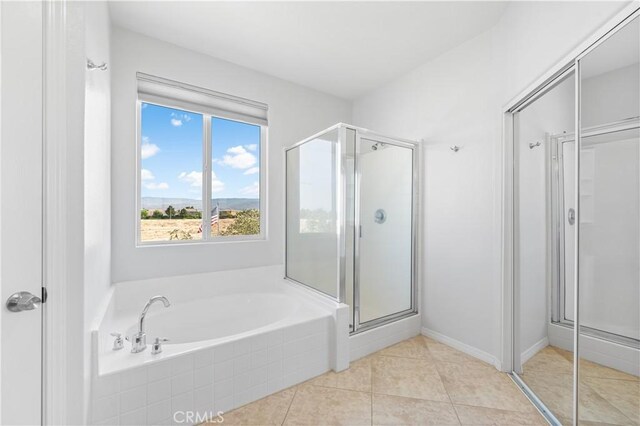 4604 Trojan Ct, Lancaster, CA 93536 - full bathroom featuring a stall shower, a bath, and tile patterned flooring