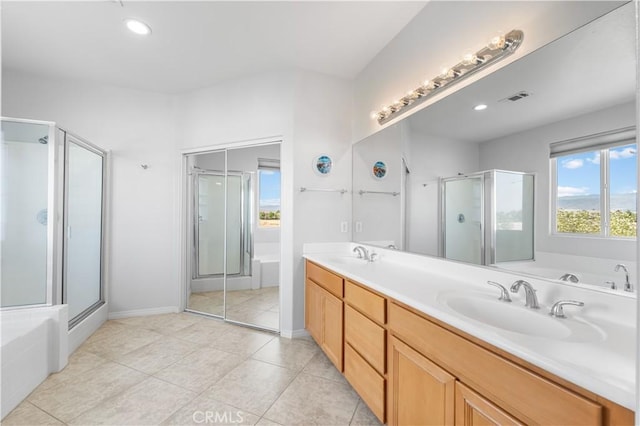 4604 Trojan Ct, Lancaster, CA 93536 - bathroom featuring a stall shower, a bath, double vanity, tile patterned flooring, and recessed lighting
