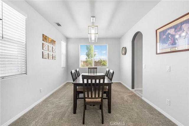 4604 Trojan Ct, Lancaster, CA 93536 - carpeted dining area featuring arched walkways and baseboards