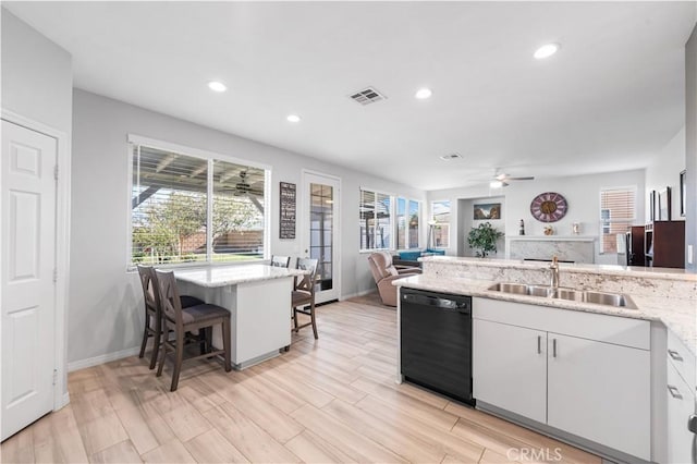 4604 Trojan Ct, Lancaster, CA 93536 - kitchen featuring dishwasher, a ceiling fan, open floor plan, recessed lighting, and white cabinetry