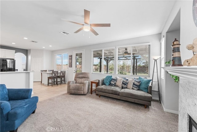 4604 Trojan Ct, Lancaster, CA 93536 - living area with ceiling fan, light carpet, a fireplace, and recessed lighting