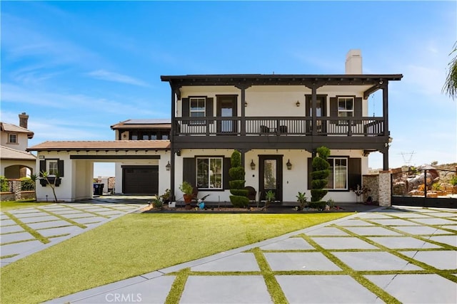 5156 Branding Iron Pl, Rancho Cucamonga, CA 91739 - view of front of property featuring a balcony, stucco siding, a front yard, and a chimney