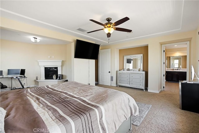 5156 Branding Iron Pl, Rancho Cucamonga, CA 91739 - bedroom with light carpet, a glass covered fireplace, and a ceiling fan