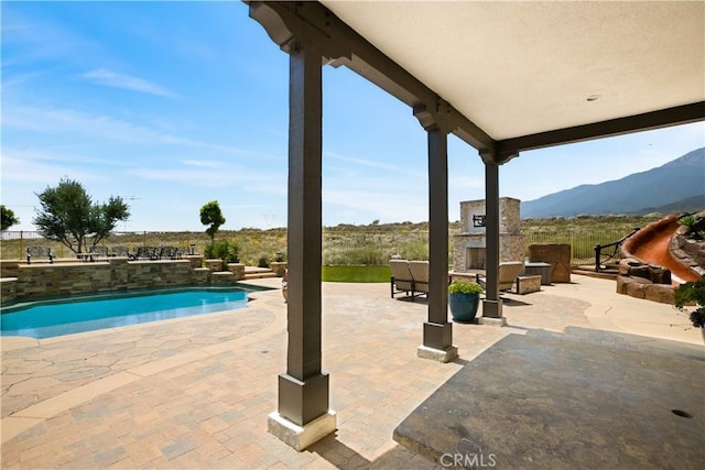 5156 Branding Iron Pl, Rancho Cucamonga, CA 91739 - outdoor pool featuring a patio area, an outdoor stone fireplace, and a mountain view