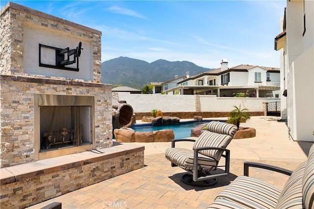 5156 Branding Iron Pl, Rancho Cucamonga, CA 91739 - view of patio / terrace featuring an outdoor fireplace and a mountain view