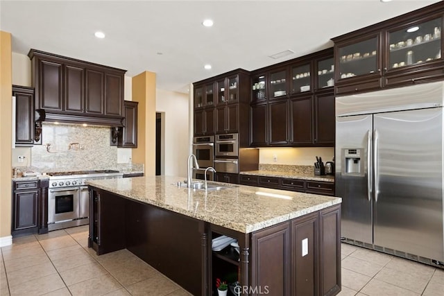 5156 Branding Iron Pl, Rancho Cucamonga, CA 91739 - kitchen with appliances with stainless steel finishes, light tile patterned floors, backsplash, dark brown cabinets, and recessed lighting