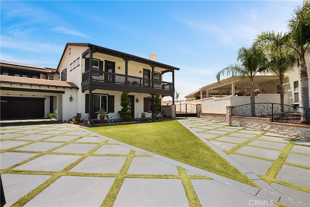 5156 Branding Iron Pl, Rancho Cucamonga, CA 91739 - back of property featuring a balcony, stucco siding, a chimney, concrete driveway, and a lawn