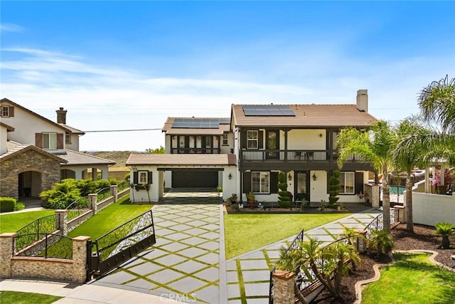 5156 Branding Iron Pl, Rancho Cucamonga, CA 91739 - view of front of home with a gate, roof mounted solar panels, a garage, stucco siding, and driveway