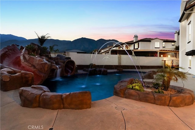 5156 Branding Iron Pl, Rancho Cucamonga, CA 91739 - pool at dusk featuring a mountain view, a patio area, and a swimming pool