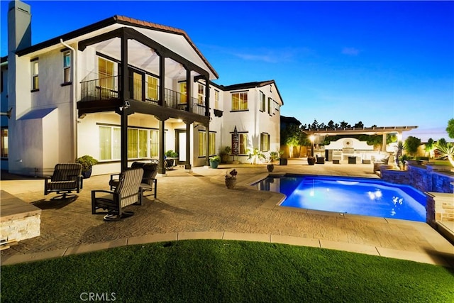 5156 Branding Iron Pl, Rancho Cucamonga, CA 91739 - back of property featuring a balcony, a patio, a chimney, an outdoor pool, and an outdoor living space