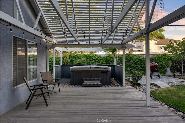 12528 Sonora Way, Victorville, CA 92392 - deck at dusk with a hot tub, a pergola, and a grill