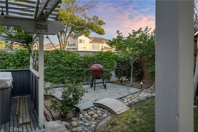12528 Sonora Way, Victorville, CA 92392 - patio terrace at dusk featuring a patio, a grill, and a pergola