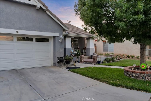 12528 Sonora Way, Victorville, CA 92392 - view of front of house with stucco siding, driveway, a yard, and a tile roof