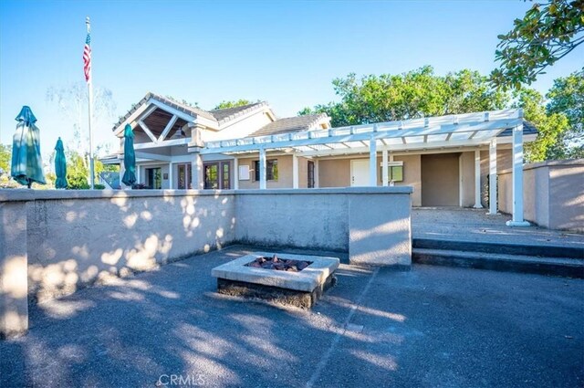 247 Oakwood Ct, Arroyo Grande, CA 93420 - view of front of home featuring an outdoor fire pit, stucco siding, and a pergola
