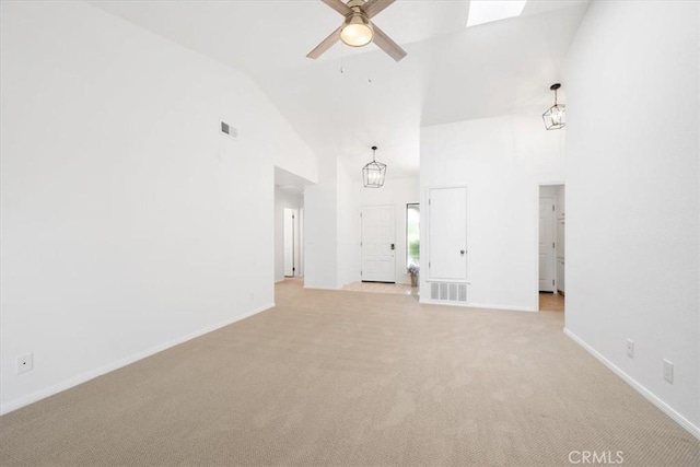 247 Oakwood Ct, Arroyo Grande, CA 93420 - unfurnished living room with high vaulted ceiling, a ceiling fan, light carpet, and a chandelier