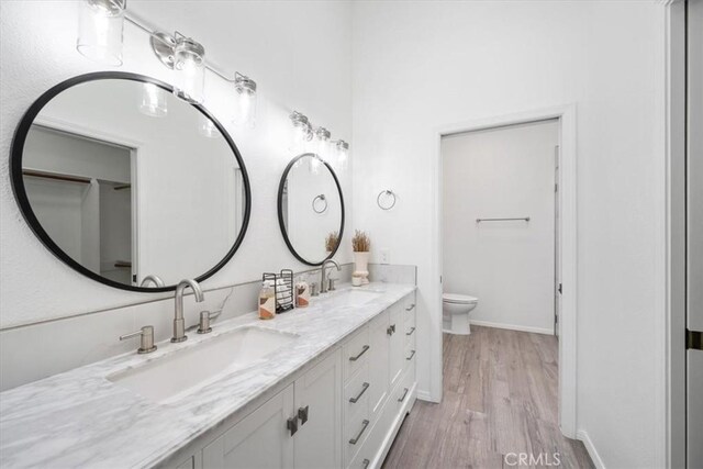 247 Oakwood Ct, Arroyo Grande, CA 93420 - bathroom with double vanity and wood finished floors