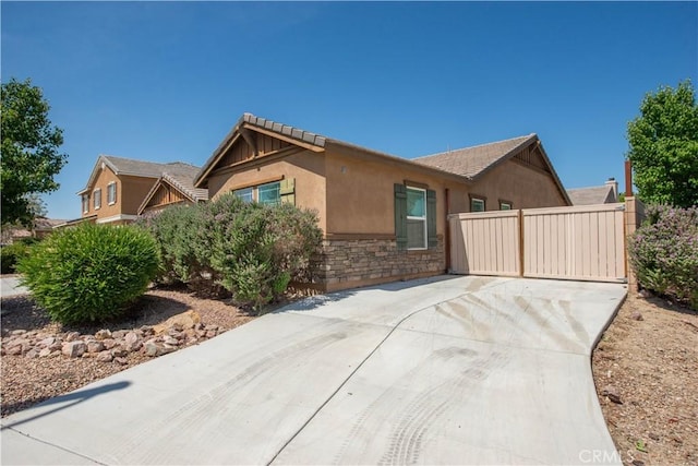44255 Cajun St, Lancaster, CA 93535 - single story home with stone siding, driveway, and stucco siding
