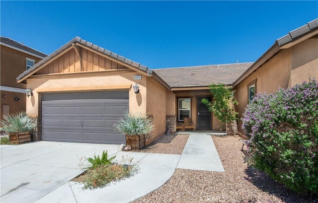 44255 Cajun St, Lancaster, CA 93535 - view of front of property with an attached garage, stucco siding, driveway, stone siding, and a tiled roof