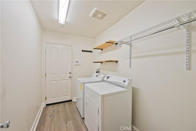 44255 Cajun St, Lancaster, CA 93535 - washroom with washing machine and clothes dryer and light wood-style flooring