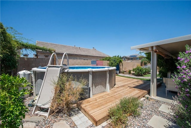 44255 Cajun St, Lancaster, CA 93535 - view of swimming pool featuring a fenced backyard and a wooden deck