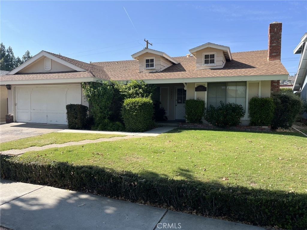 19615 Cedarcreek St, Canyon Country, CA 91351 - view of front of home featuring a front lawn, an attached garage, concrete driveway, a shingled roof, and a chimney