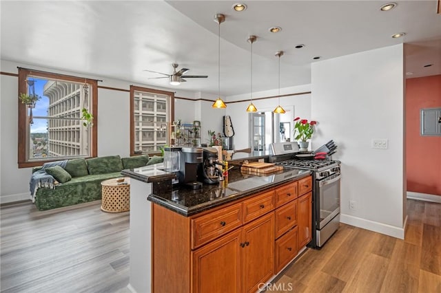 455 E Ocean Blvd Unit 911, Long Beach, CA 90802 - kitchen with stainless steel gas range, a ceiling fan, light wood-style flooring, brown cabinets, and recessed lighting