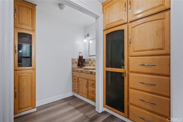 455 E Ocean Blvd Unit 911, Long Beach, CA 90802 - bathroom with vanity, wood finished floors, and decorative backsplash