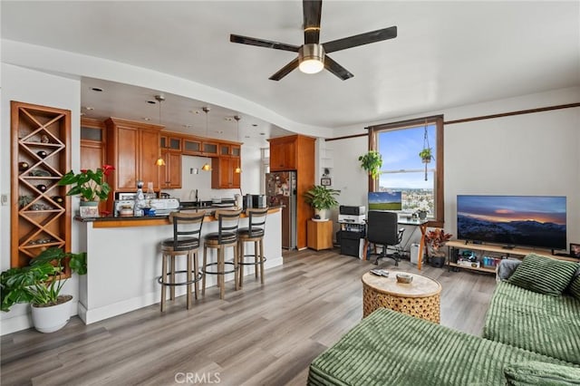 455 E Ocean Blvd Unit 911, Long Beach, CA 90802 - living area with light wood-style flooring, ceiling fan, and a desk