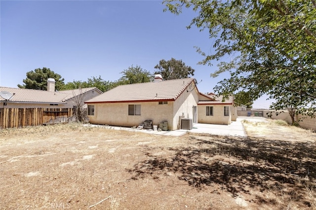 44105 Acacia St, Lancaster, CA 93535 - rear view of property with a tile roof, a fenced backyard, stucco siding, and a chimney