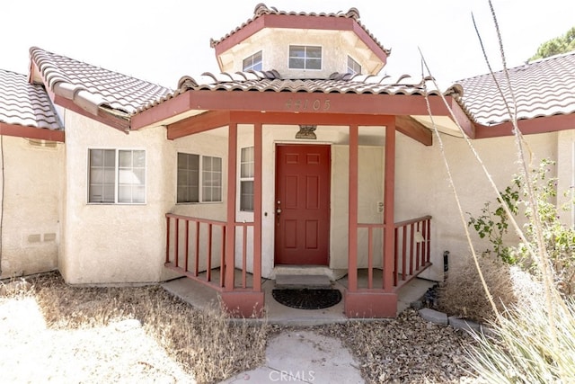 44105 Acacia St, Lancaster, CA 93535 - doorway to property featuring stucco siding and a tiled roof