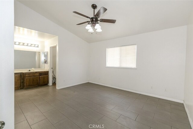 44105 Acacia St, Lancaster, CA 93535 - unfurnished bedroom featuring vaulted ceiling, ensuite bathroom, and a ceiling fan