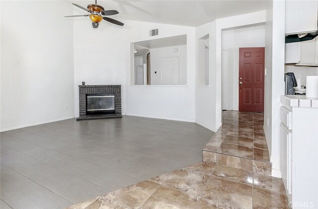 44105 Acacia St, Lancaster, CA 93535 - unfurnished living room with a ceiling fan, lofted ceiling, and a fireplace