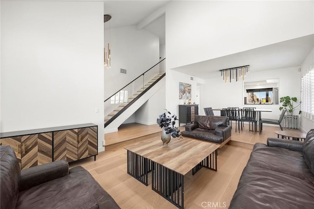 1041 S Falling Leaf Cir, Anaheim Hills, CA 92807 - living room with light wood finished floors, high vaulted ceiling, and stairway