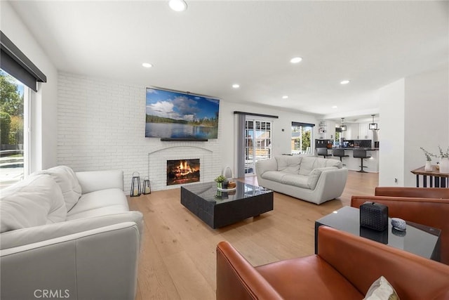 1041 S Falling Leaf Cir, Anaheim Hills, CA 92807 - living room featuring light wood-style floors, recessed lighting, and a brick fireplace