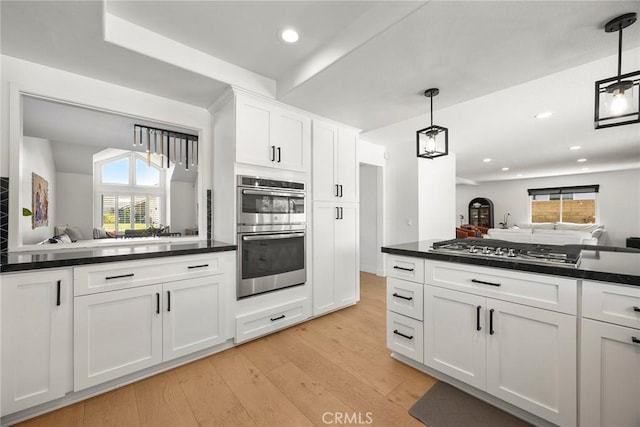 1041 S Falling Leaf Cir, Anaheim Hills, CA 92807 - kitchen featuring appliances with stainless steel finishes, dark countertops, light wood finished floors, healthy amount of natural light, and recessed lighting