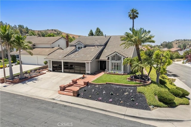 1041 S Falling Leaf Cir, Anaheim Hills, CA 92807 - view of front of property featuring a garage, a tile roof, concrete driveway, and a front yard