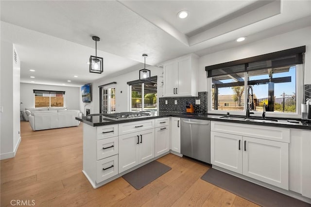 1041 S Falling Leaf Cir, Anaheim Hills, CA 92807 - kitchen with stainless steel appliances, a peninsula, dark countertops, white cabinets, and recessed lighting