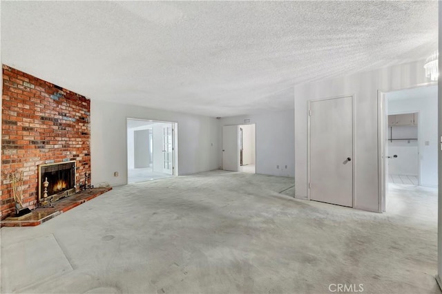 1510 E Newcrest Dr, West Covina, CA 91792 - unfurnished living room featuring a textured ceiling and a brick fireplace