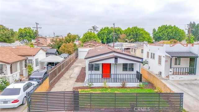 223 E 83rd St, Los Angeles, CA 90003 - bungalow-style house with a fenced front yard and a residential view