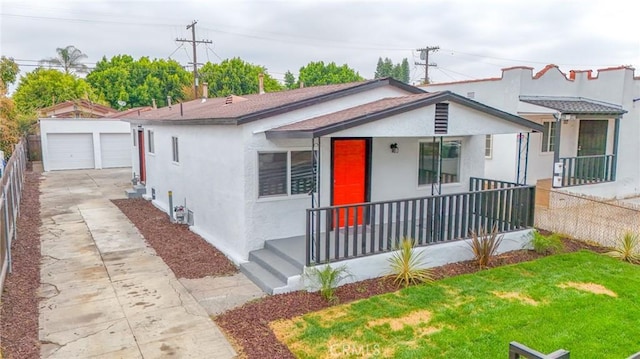 223 E 83rd St, Los Angeles, CA 90003 - view of front of home with stucco siding, a porch, an outdoor structure, and concrete driveway
